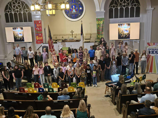 Large group of children standing in front of altar at church